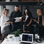 Young team works with documents and discuss the project in a stylish modern office. Work process in the office.